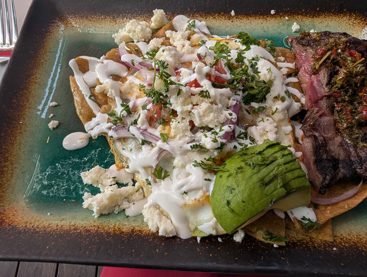 Plated entree with a green component and grilled protein