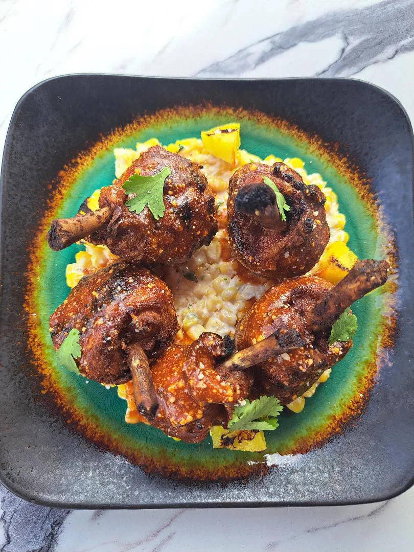 Overhead plated dish with grilled protein and colorful garnish